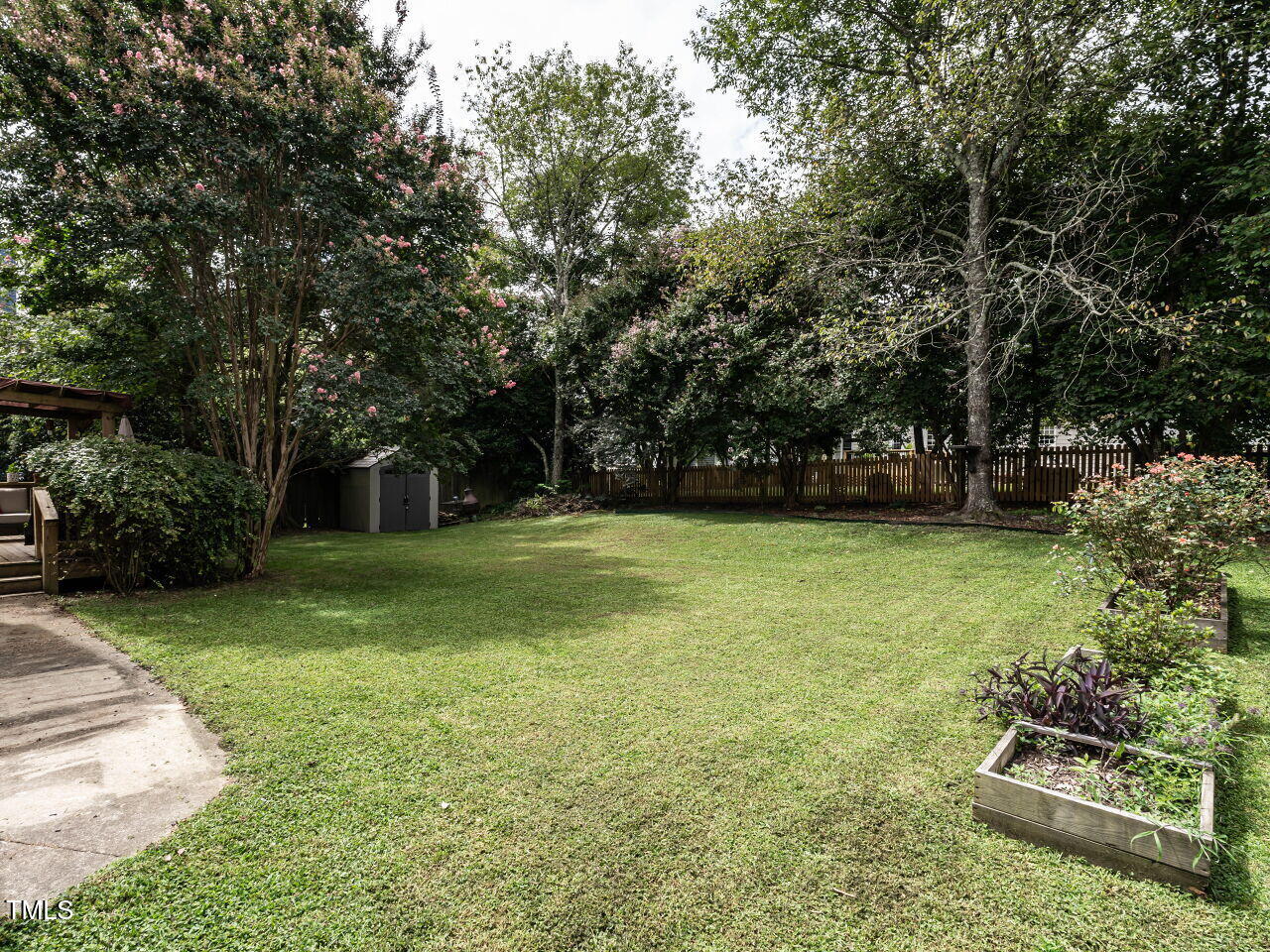 9205 Dawnshire Road Raleigh, NC 27615 - Photo 27 of 30 a view of a garden with large trees