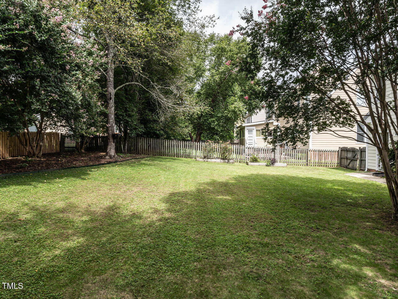 9205 Dawnshire Road Raleigh, NC 27615 - Photo 29 of 30 a backyard of a house with lots of green space and fountain