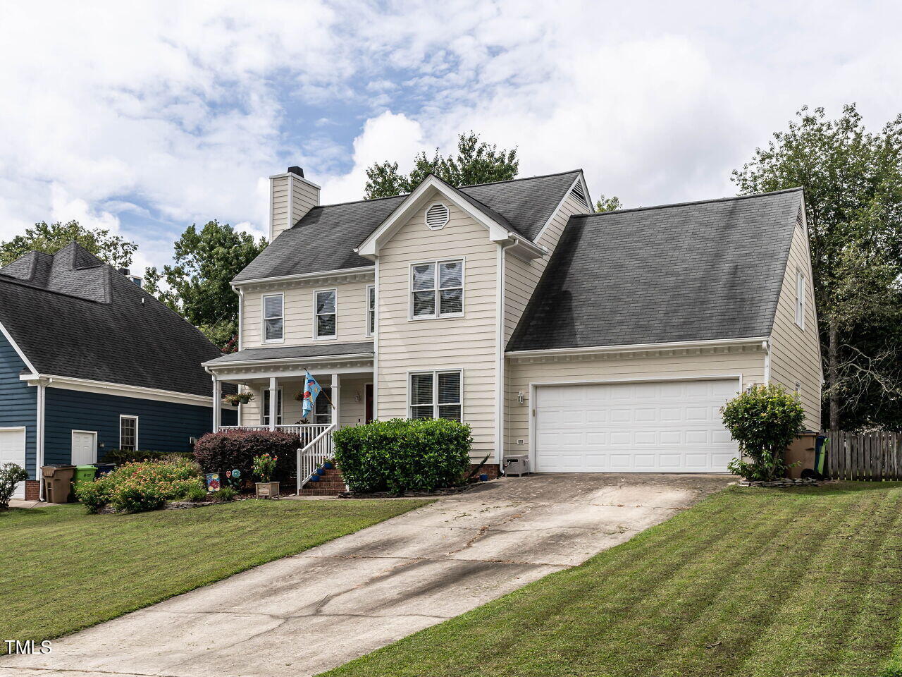 9205 Dawnshire Road Raleigh, NC 27615 - Photo 3 of 30 a front view of a house with a yard and garage