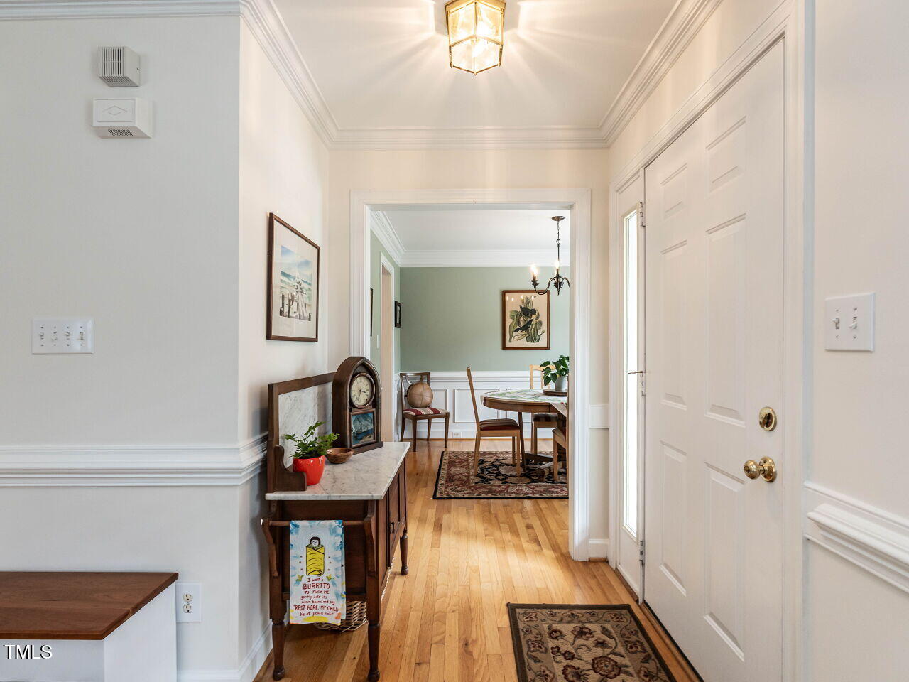 9205 Dawnshire Road Raleigh, NC 27615 - Photo 4 of 30 a view of a hallway to a livingroom with wooden floor and furniture