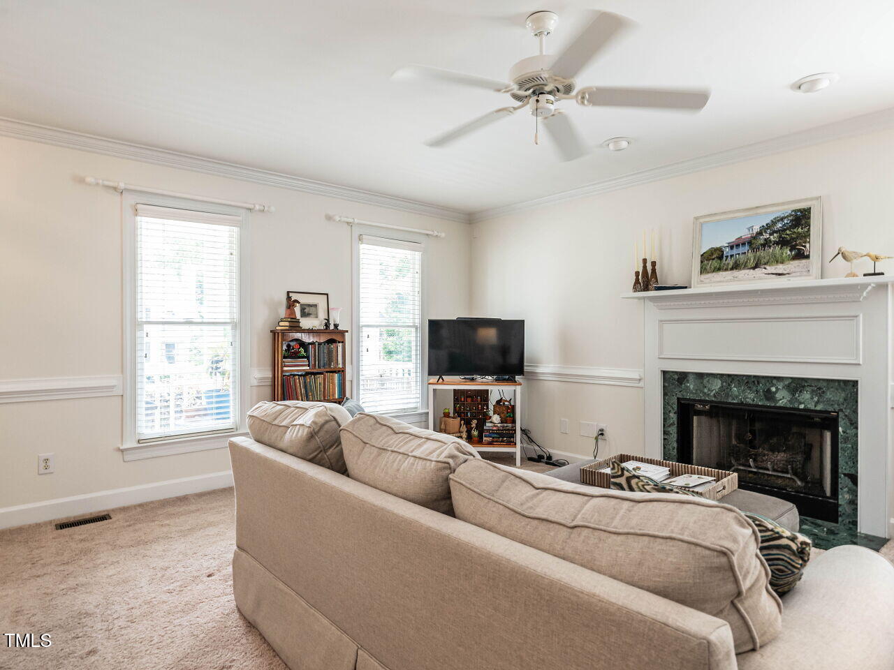 9205 Dawnshire Road Raleigh, NC 27615 - Photo 9 of 30 a living room with furniture a fireplace and a flat screen tv