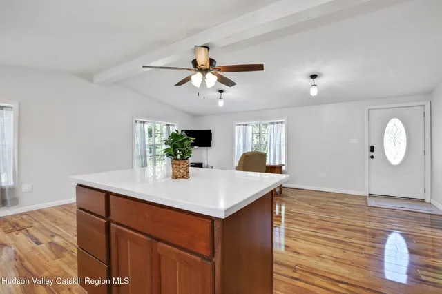 a view of kitchen island sink and wooden floor