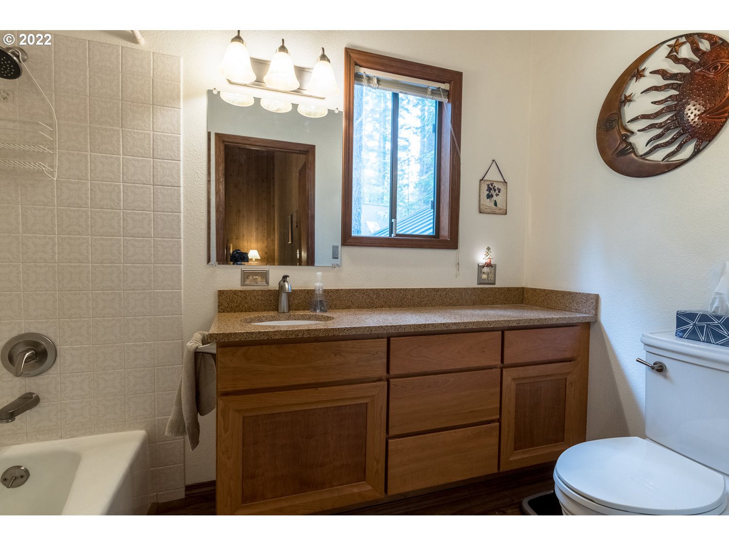 72671 East Village Loop Road Rhododendron, OR 97049 - Photo 24 of 32 a bathroom with a sink a mirror a toilet and a window
