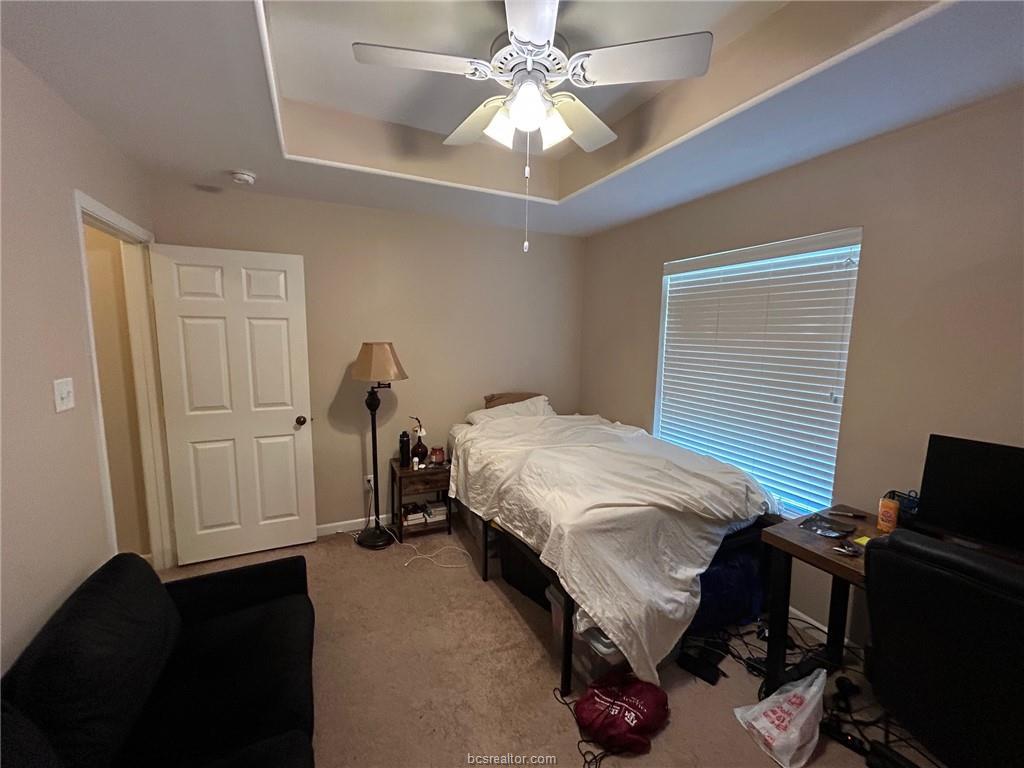 300 Ash Street, Unit B College Station, TX 77840 - Photo 11 of 23 a bedroom with bed and a chandelier