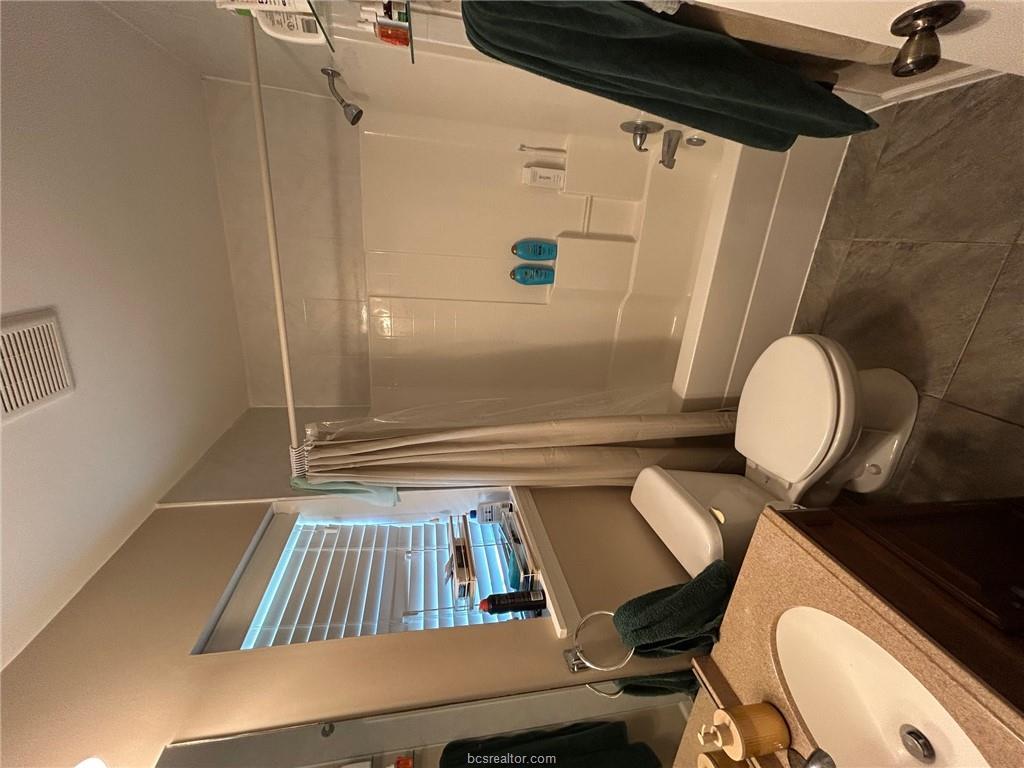 300 Ash Street, Unit B College Station, TX 77840 - Photo 12 of 23 a bathroom with a sink toilet and shower