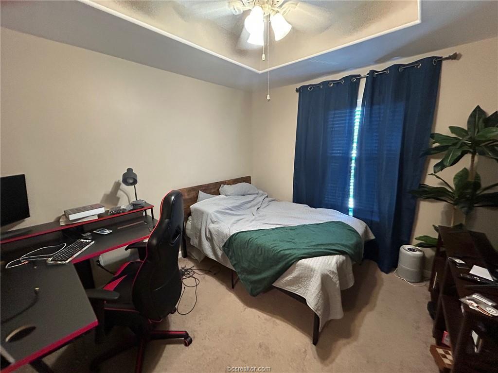 300 Ash Street, Unit B College Station, TX 77840 - Photo 13 of 23 a bedroom with a bed and a chandelier