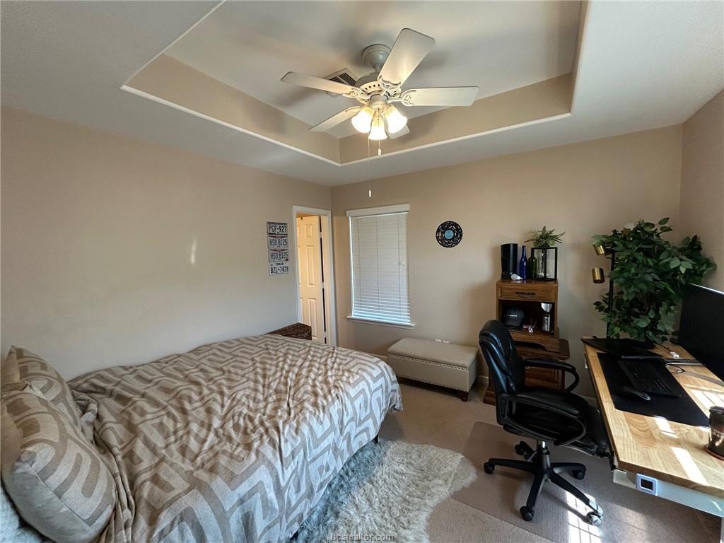 300 Ash Street, Unit B College Station, TX 77840 - Photo 16 of 23 a bedroom with a bed and a chandelier