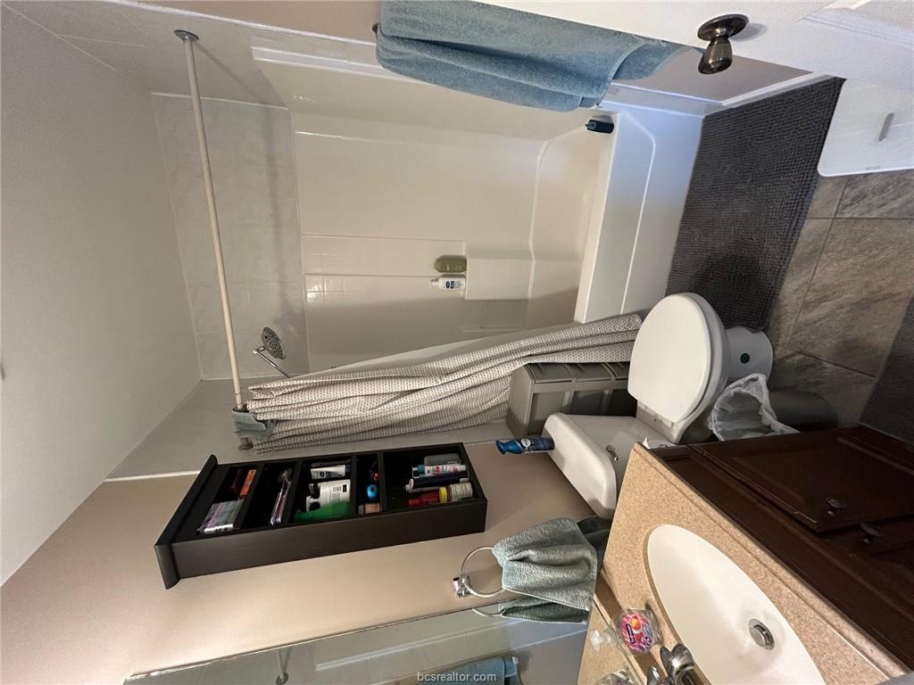 300 Ash Street, Unit B College Station, TX 77840 - Photo 18 of 23 a bathroom with a sink toilet and shower