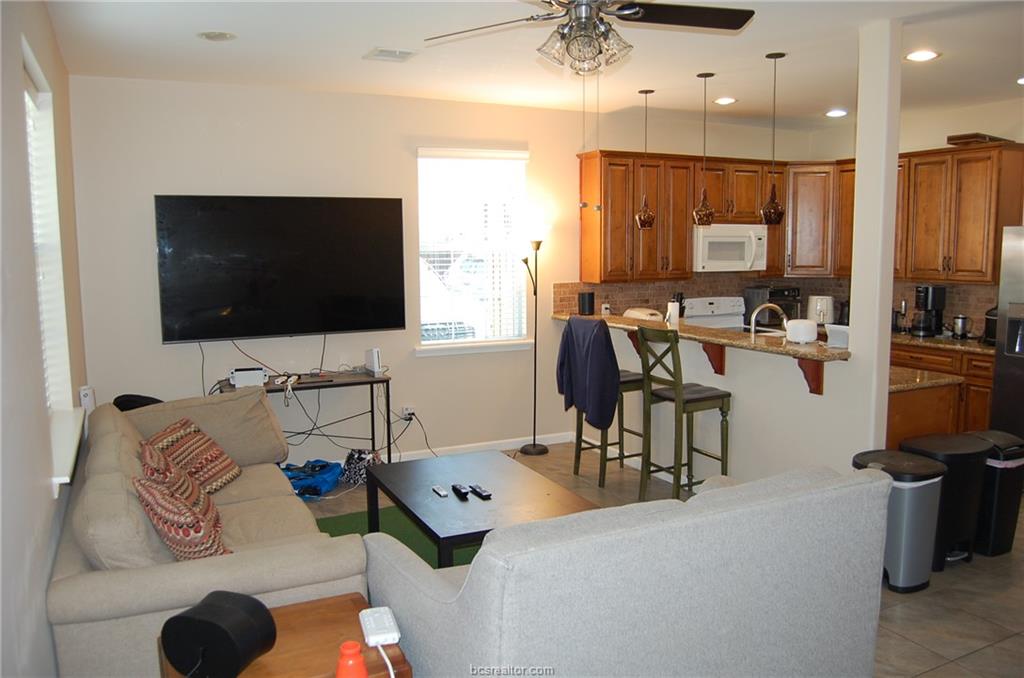 300 Ash Street, Unit B College Station, TX 77840 - Photo 4 of 23 a living room with furniture and a flat screen tv