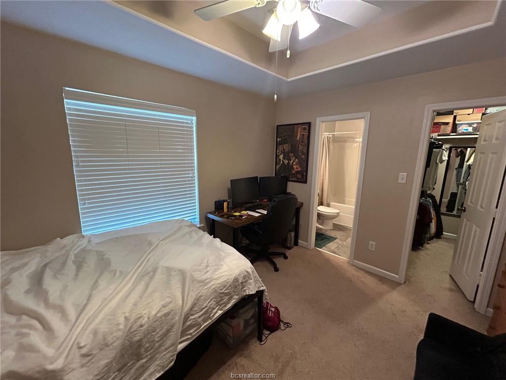 300 Ash Street, Unit B College Station, TX 77840 - Photo 10 of 23 a bedroom with a bed and a chandelier