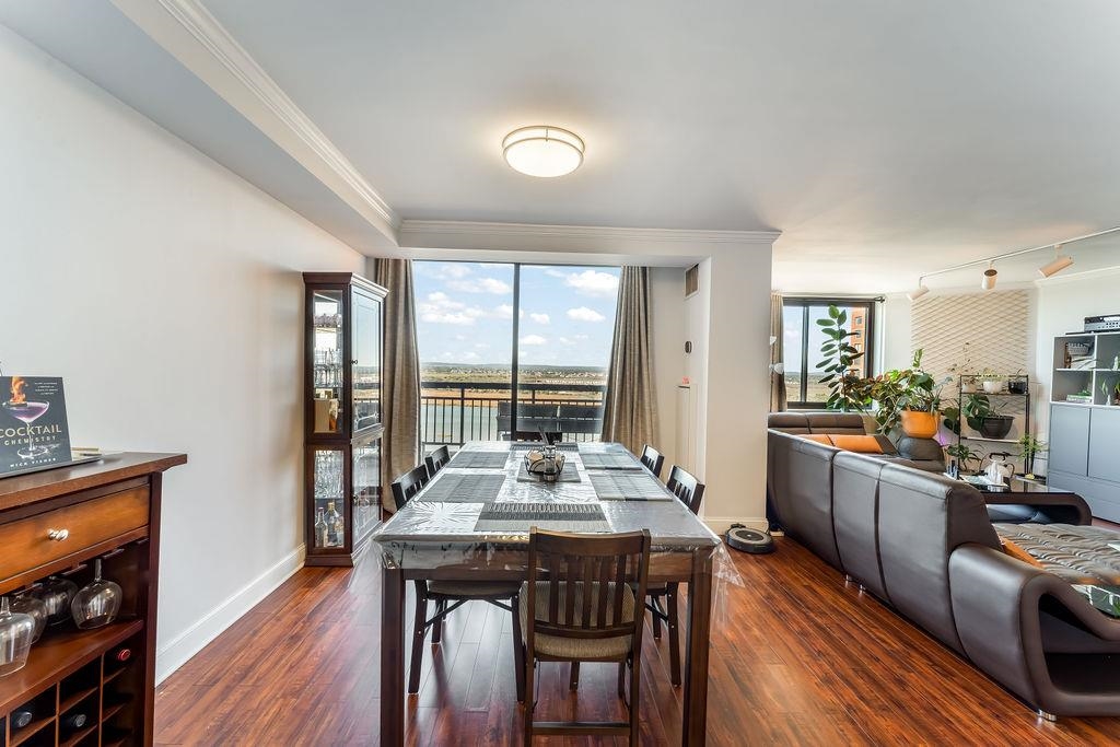 2110 Harmon Cove Tower Secaucus, NJ 07094 - Photo 13 of 50 a view of a dining room with furniture window and wooden floor