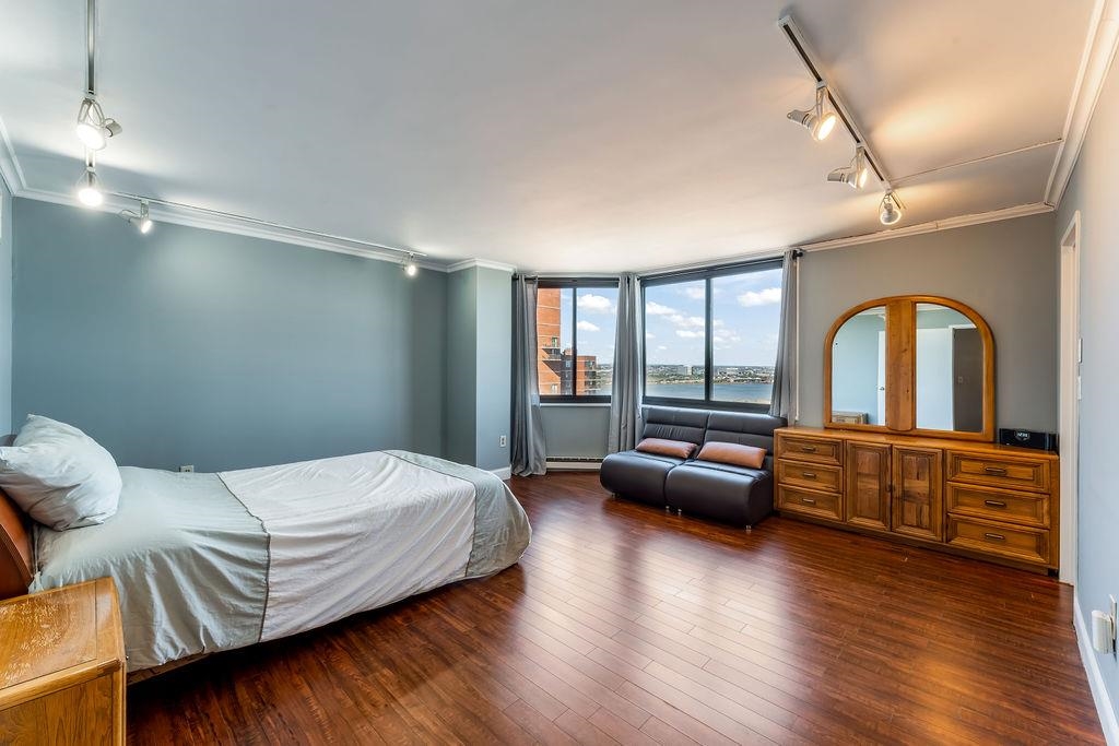 2110 Harmon Cove Tower Secaucus, NJ 07094 - Photo 20 of 50 a bedroom with a large bed and a large window