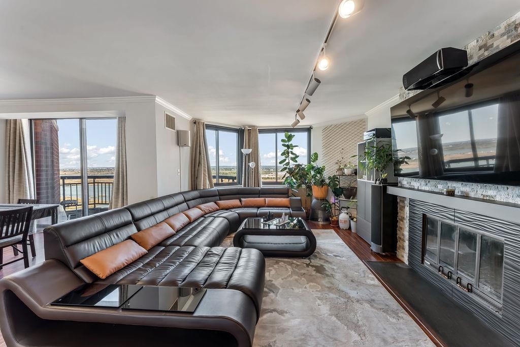 2110 Harmon Cove Tower Secaucus, NJ 07094 - Photo 2 of 50 a living room with furniture fireplace and flat screen tv