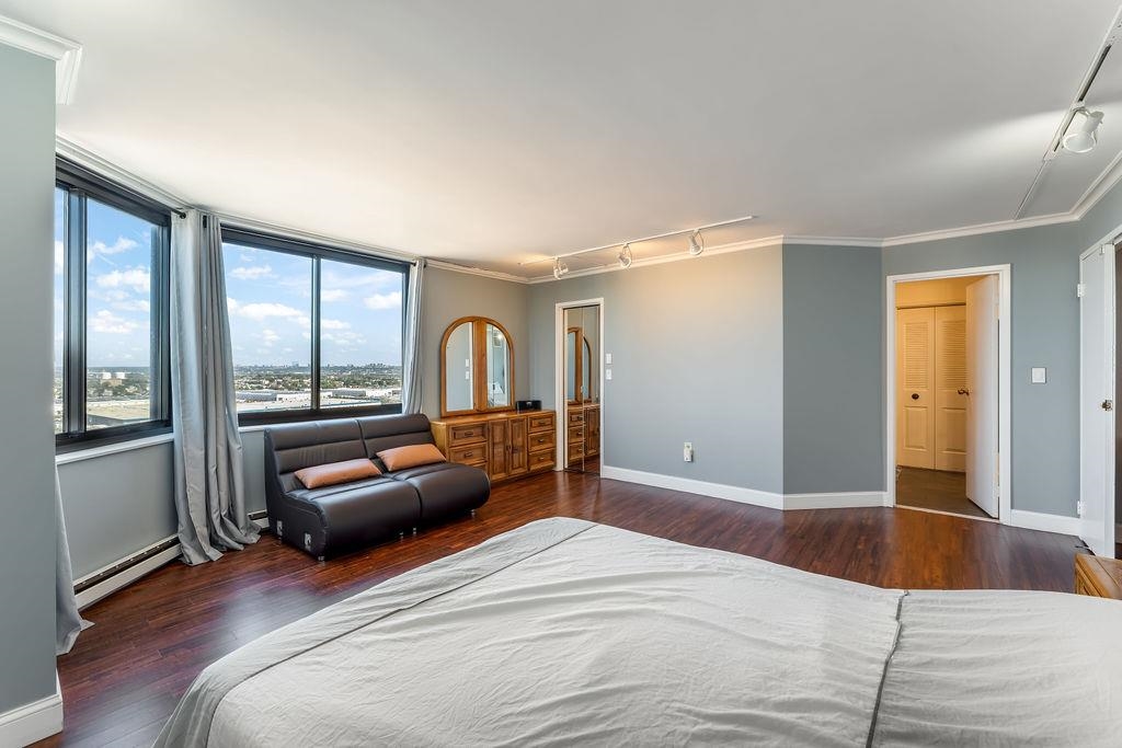 2110 Harmon Cove Tower Secaucus, NJ 07094 - Photo 21 of 50 a bedroom with a bed and a large window