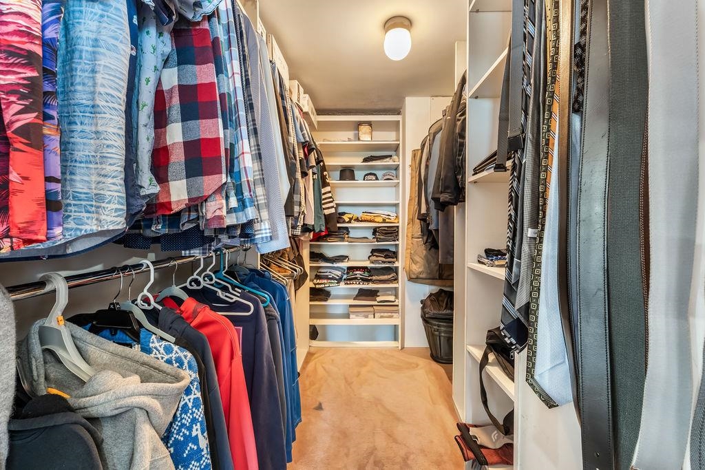 2110 Harmon Cove Tower Secaucus, NJ 07094 - Photo 24 of 50 a view of walk in closet with clothes and shoes