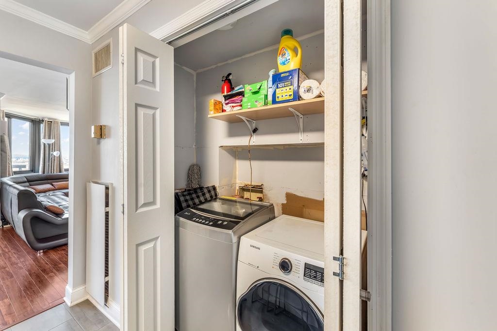2110 Harmon Cove Tower Secaucus, NJ 07094 - Photo 38 of 50 a view of a bedroom with washer and dryer