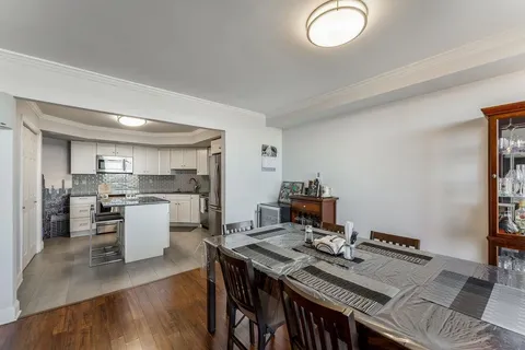 a kitchen with a stove and white cabinets