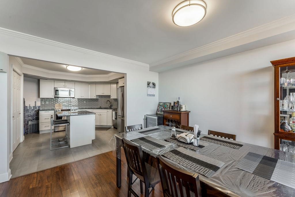 2110 Harmon Cove Tower Secaucus, NJ 07094 - Photo 7 of 50 a kitchen with a stove and white cabinets