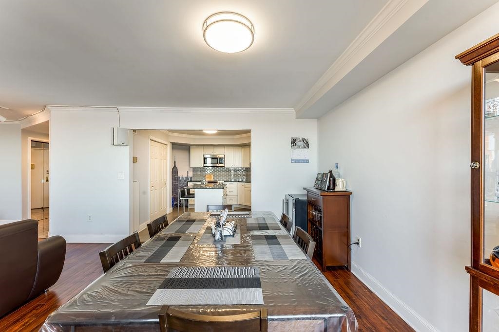 2110 Harmon Cove Tower Secaucus, NJ 07094 - Photo 8 of 50 a living room with furniture and a wooden floor