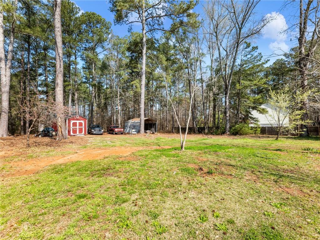 1686 Shoal Creek Road Monroe, GA 30656 - Photo 37 of 50 a swimming pool with trees in the background