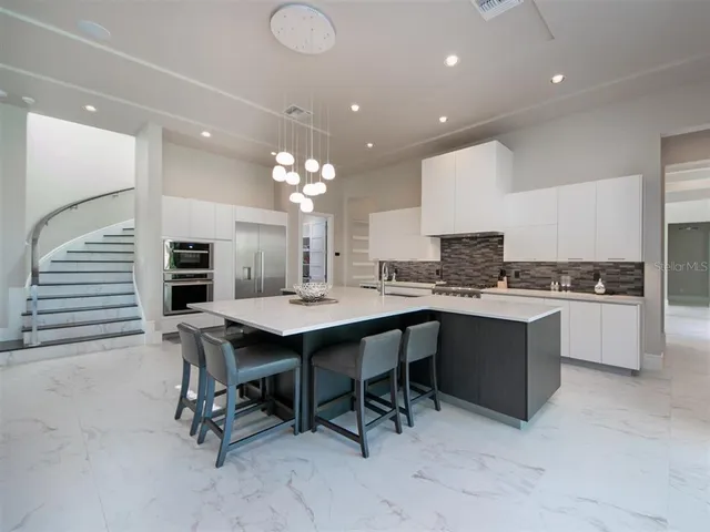 a kitchen with a table and chairs in it