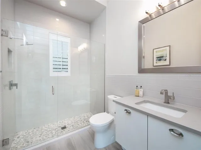 a bathroom with a sink toilet and shower