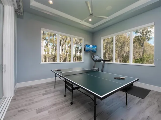a room with pool table and windows