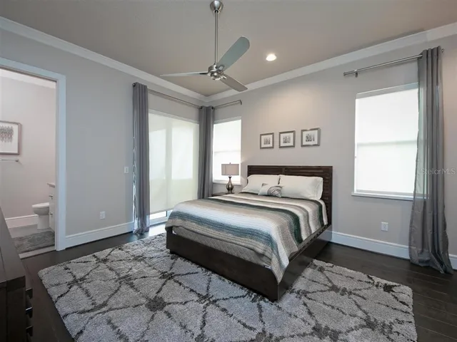 a spacious bedroom with a bed and a window