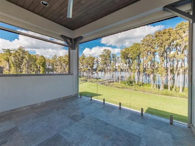 a bedroom with a bed chandelier and a window