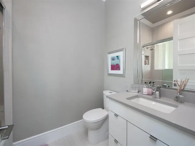 a bedroom with a bed and a mirror