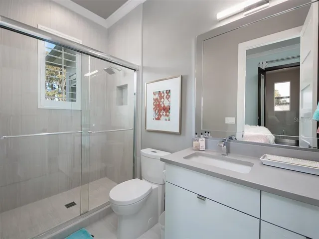 a bedroom with a bed window and a table