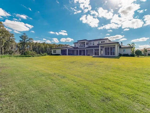 an aerial view of a house with garden space seating and mountain view in back