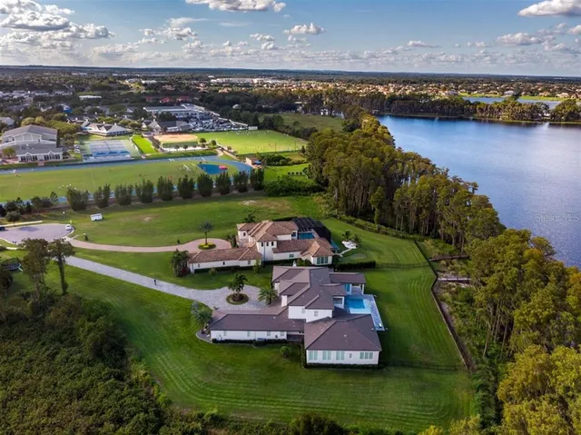 an aerial view of a house with a lake view