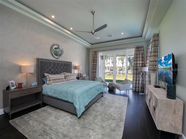 a bedroom with a bed a couch and dresser