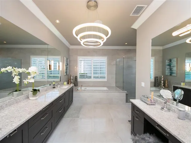 a large bathroom with a double vanity sink a large mirror and a bathtub