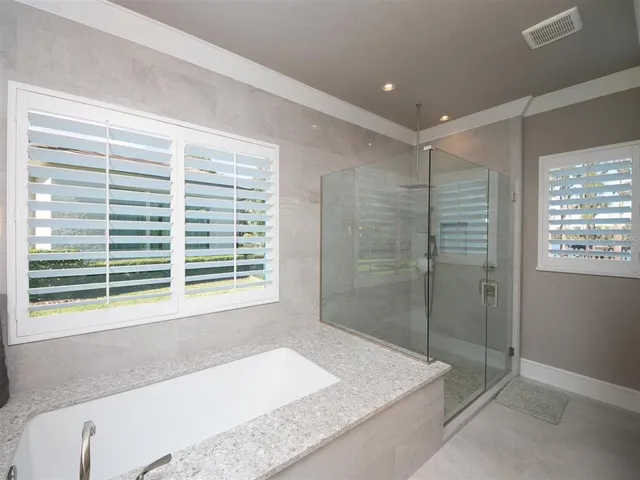 a bathroom with a bathtub and a shower