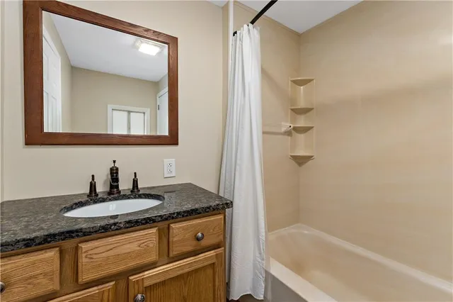 a kitchen with a sink window and cabinets