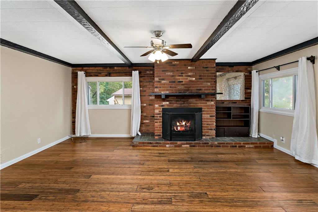 130 Patton Lane Clinton, PA 15026 - Photo 2 of 36 a view of empty room with wooden floor fireplace and a window