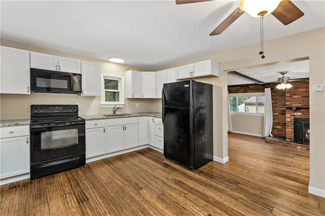 a kitchen with stainless steel appliances a refrigerator sink and microwave
