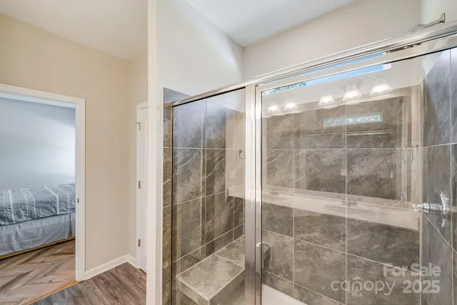 a bathroom with a glass shower door