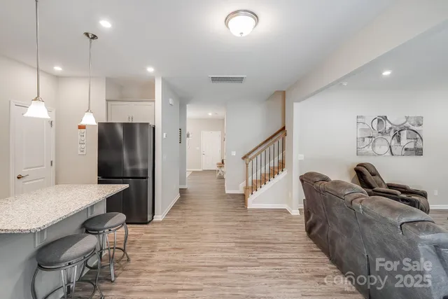 a large kitchen with a table and chairs