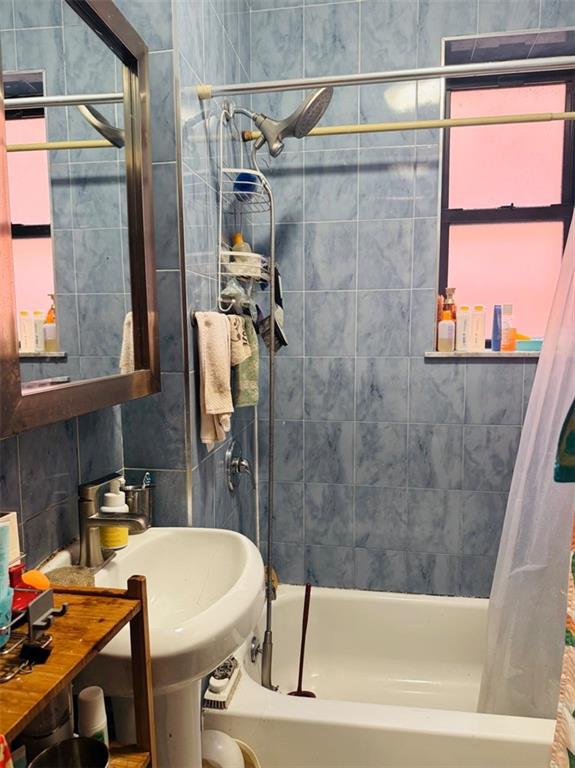 328 91st Street Brooklyn, NY 11209 - Photo 14 of 27 a bathroom with a sink and a bathtub