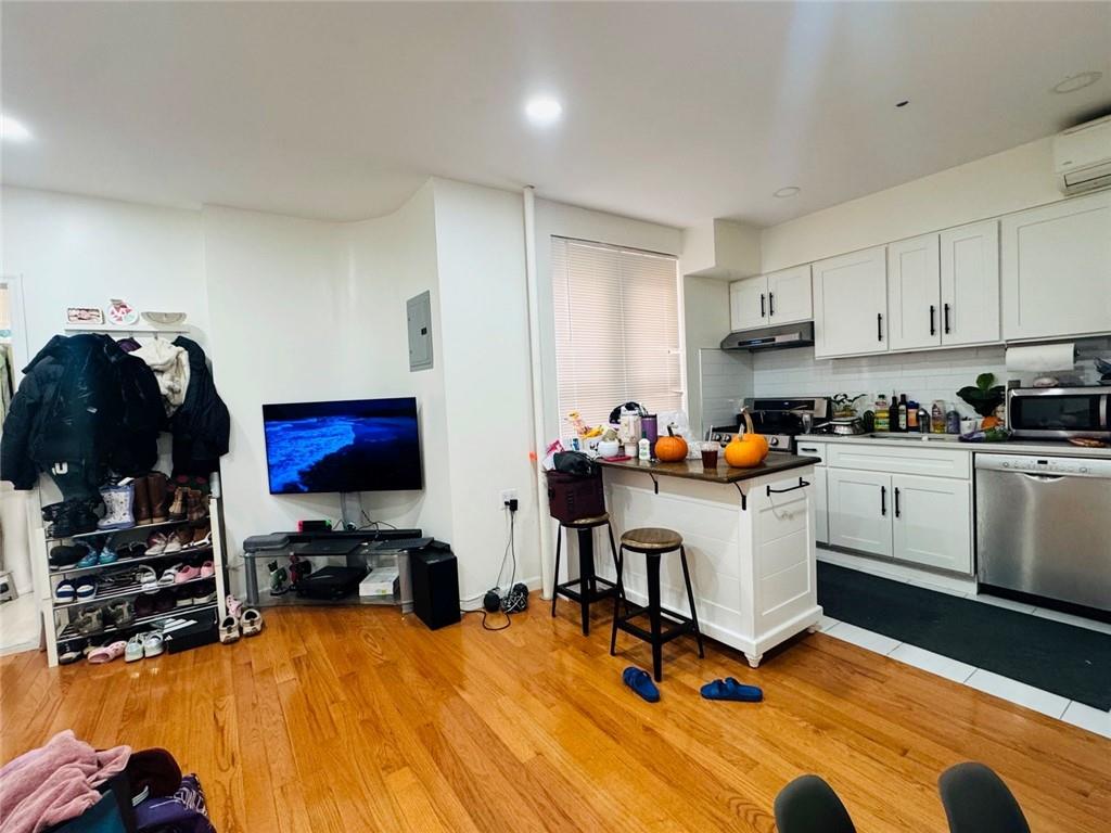 328 91st Street Brooklyn, NY 11209 - Photo 7 of 27 a workspace with furniture and wooden floor