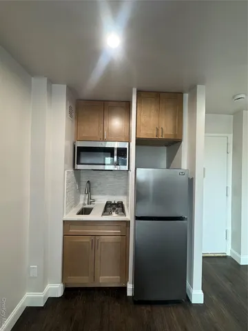 a kitchen with a refrigerator and a sink