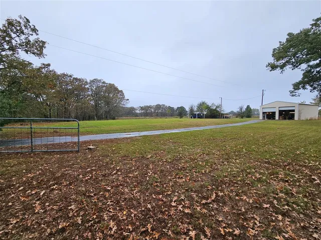 a view of a garden with a building in the background