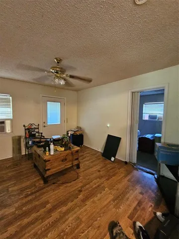 a kitchen with granite countertop a refrigerator and a stove top oven