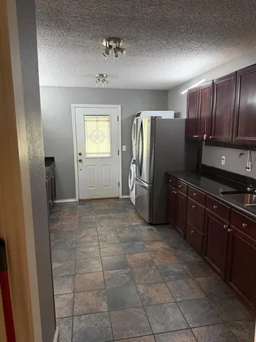 a kitchen with stainless steel appliances granite countertop a stove microwave and sink