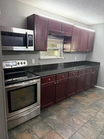 a view of a backyard with table and chairs under an umbrella