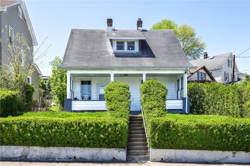 a front view of a house with garden