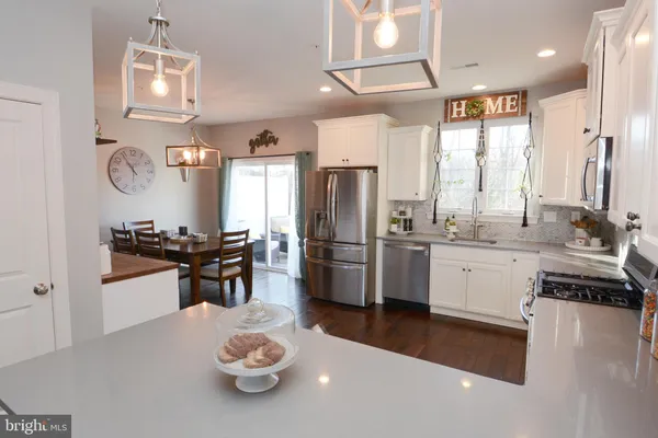 a kitchen with a table chairs and cabinets